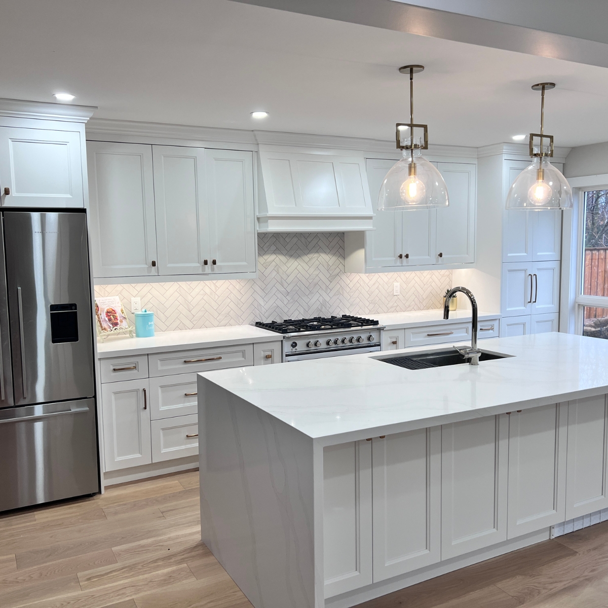 traditional kitchen with white counters and shaker doors