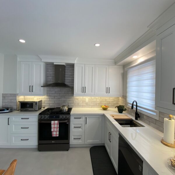 white kitchen with black appliances