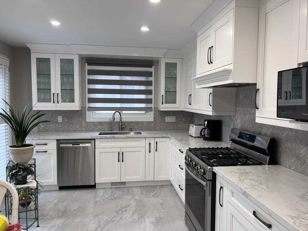White Shaker kitchen with matte black bar pulls on every cabinet and drawer in a Brampton home